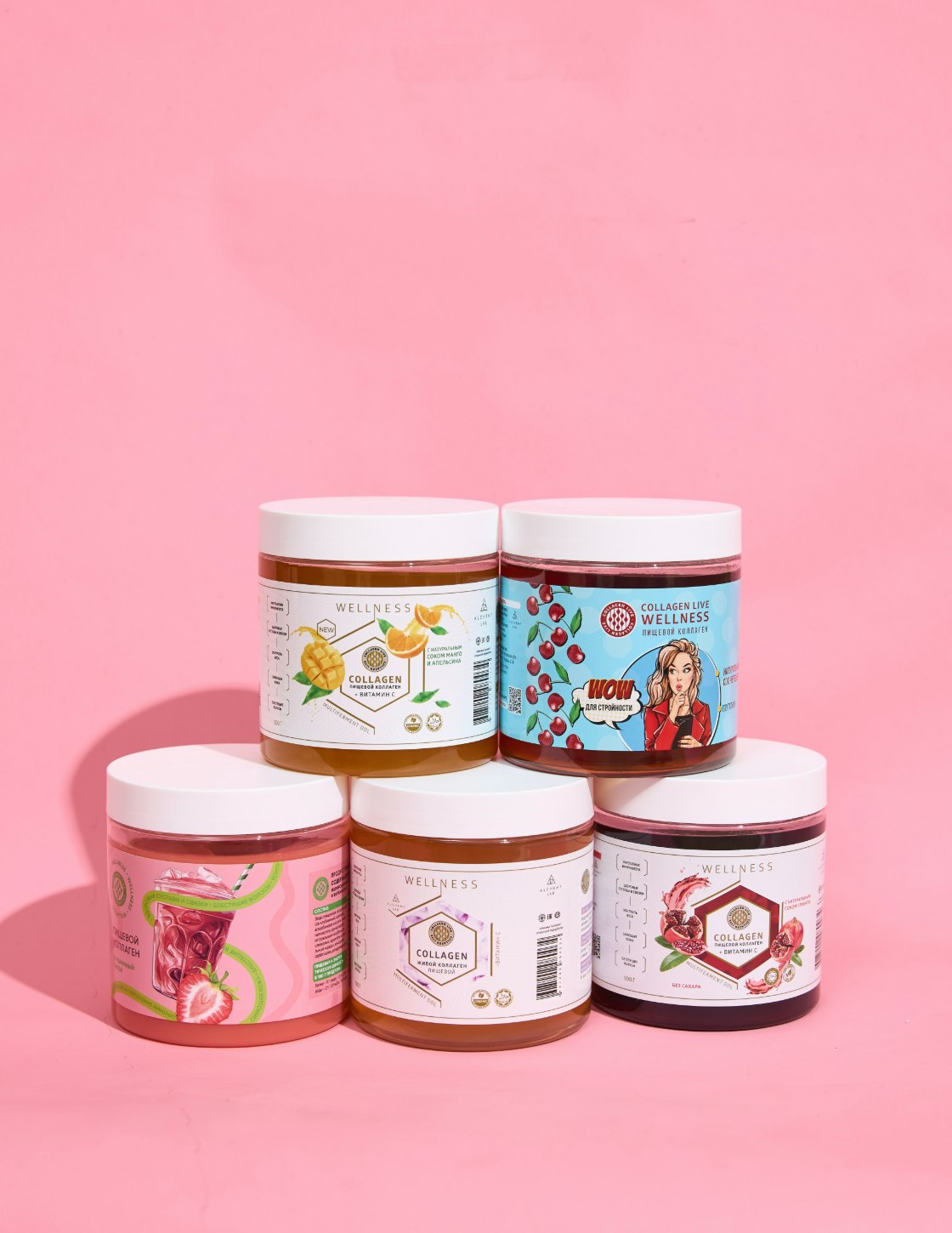 Пять банок Collagen Live разных вкусов на розовом фоне